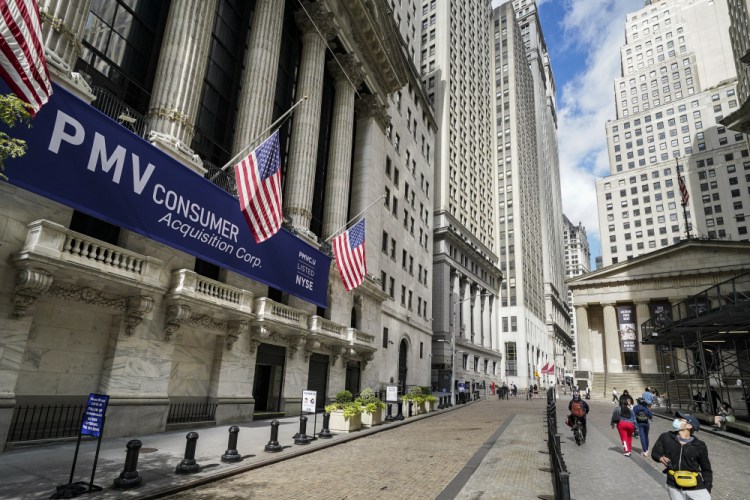 Pedestrians pass the New York Stock Exchange on Oct. 2020 in New York.    

