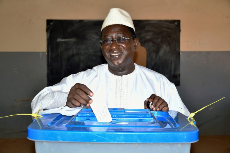 Then opposition presidential candidate Soumaila Cissé casting his ballot during the presidential second round election in Niafunke, Mali, in August 2018. Cissé has died in Paris, his family said Friday. (Boubacar Sada Sissoko/Union for the Republic and Democracy via AP, File)