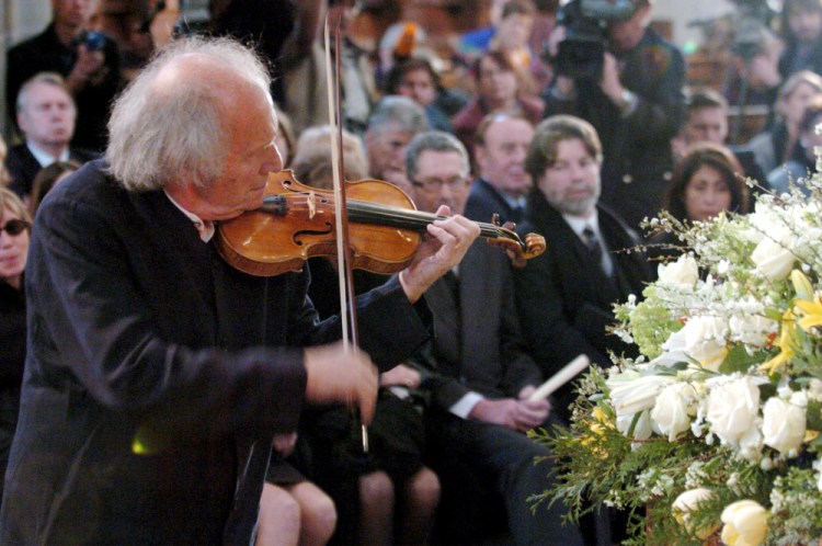 Israeli violinist Ivry Gitlis, ambassador to the UNESCO, plays at the funeral ceremony of Oscar-winning British actor and play-writer, Sir Peter Ustinov, in Geneva, Switzerland in 2004. (Martial Trezzini/Pool Photo via AP, File)