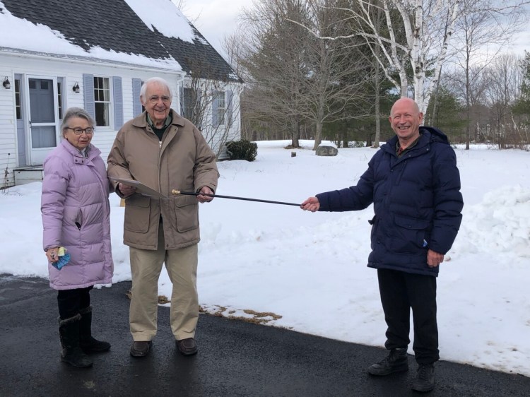 Don Welsh, right, Selectboard chairperson, presents the Wayne Cane to Lincoln Ladd on Dec. 22 at his residence, “Sunshine Hill” in Wayne, with his wife Gloria by his side. 