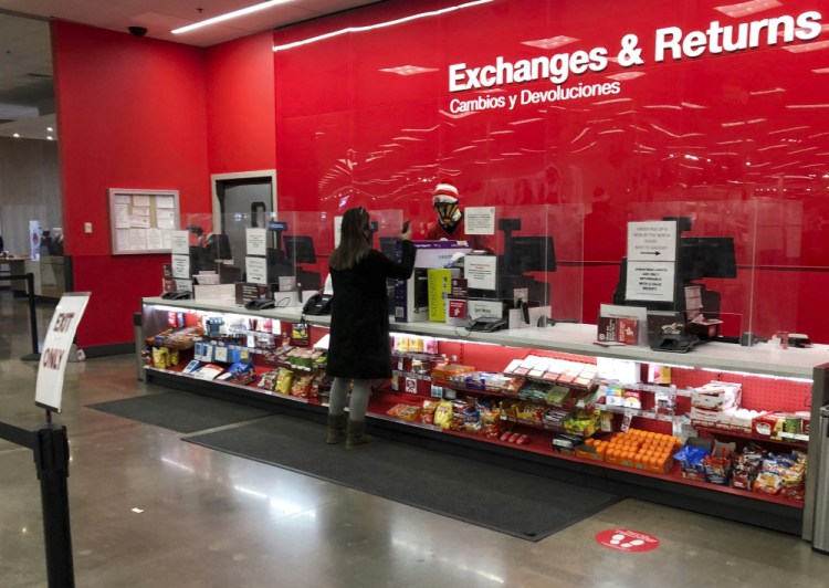 A customer is shown at the exchanges and return counter in a Target department store early Wednesday in Glendale, Colo.  
