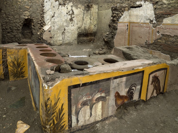 The fully excavated thermopolium in the Pompeii archeological park, near Naples, Italy. The excavation has revealed some favorite dishes of citizens of the ancient Roman city who liked to eat out. (Luigi Spina/Parco Archeologico di Pompei via AP)