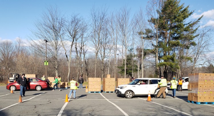 Kennebec Valley Community College students, faculty and staff and Kennebec Valley Community Action Program  employees hand out boxes of farm-grown produce on Nov. 21 to families. The event was held in the parking lot of the Fairfield college.