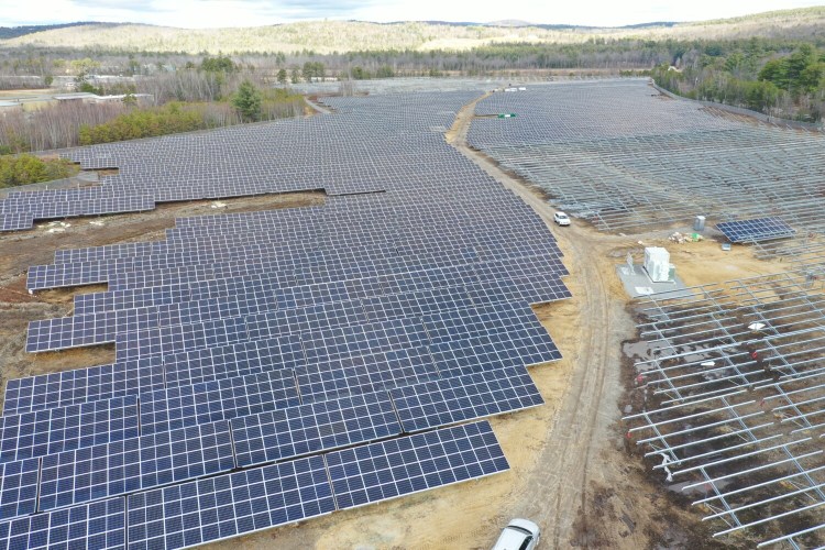 Workers are installing 30,000 solar-electric panels at the BNRG/Dirigo solar farm off Route 26 in Oxford, part of an unprecedented wave of large-scale solar projects being developed in Maine. The 38-acre site, adjacent to Oxford Plains Speedway, had been zoned for a business park. 