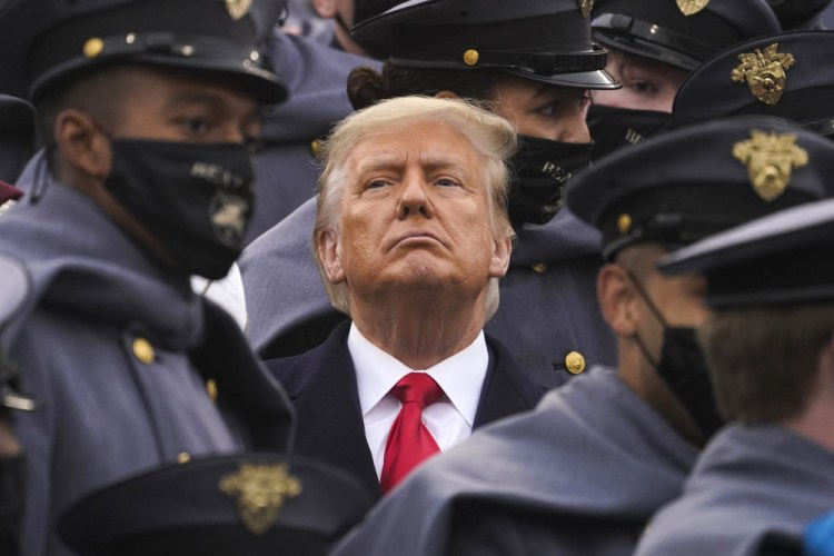 Surrounded by Army cadets, President Donald Trump watches the Army-Navy Football Game at the United States Military Academy on Dec. 12 in West Point, N.Y. Trump on Saturday downplayed possible Russian involvement in a major cyberattack against the U.S. (AP Photo/Andrew Harnik)
