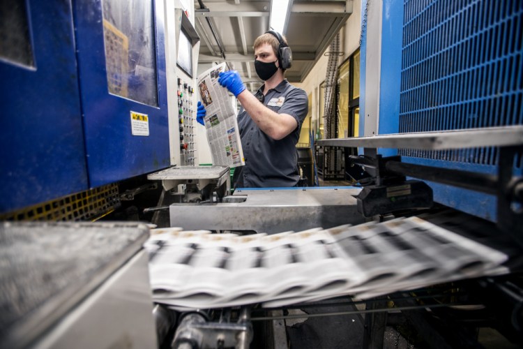 A press worker checks a newspaper as the last daily edition of the Deseret News is printed at the MediaOne building in West Valley City, Utah, on Wednesday.

