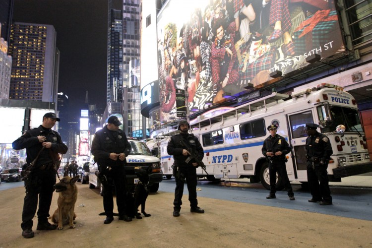 Heavily armed police officers stand guard during the New Year's Eve celebration in New York's Times Square in 2011. Although New York City police have turned to familiar tactics ahead of the iconic Thursday, Dec. 31, 2020, ball drop, the department's playbook this year includes an unusual mandate: preventing crowds from gathering in Times Square. 