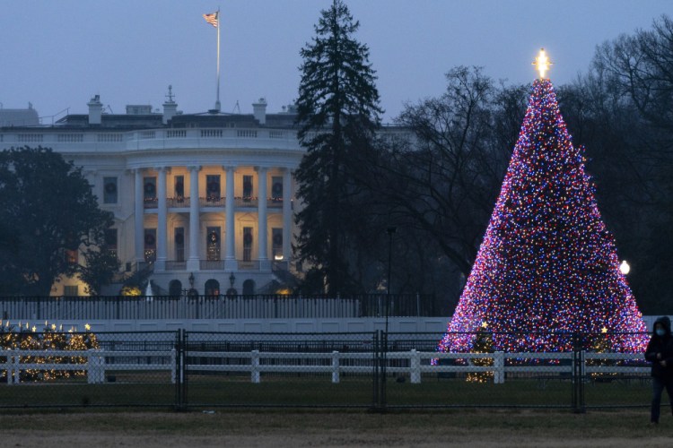 The National Christmas Tree glows with lights on the Ellipse near the White House, Thursday, on Christmas Eve in Washington.