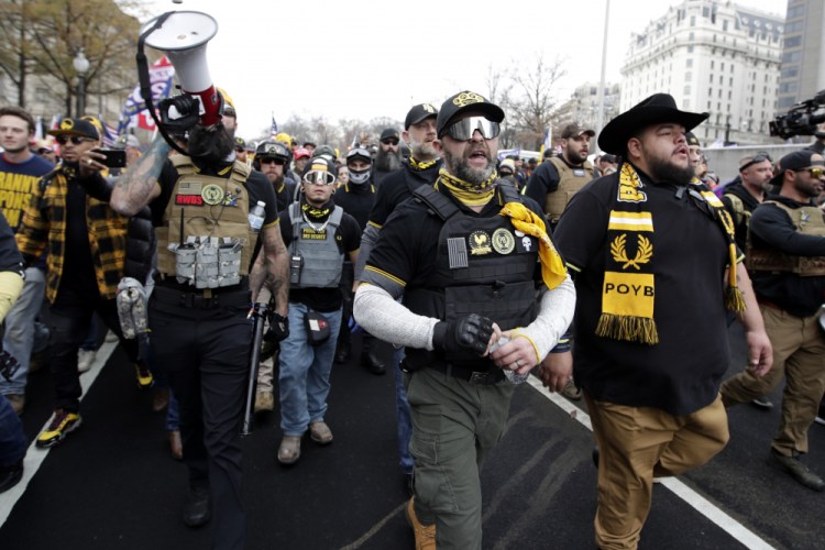 Supporters of President Donald Trump who are wearing attire associated with the Proud Boys attend a rally at Freedom Plaza, Saturday, Dec. 12, 2020, in Washington. 