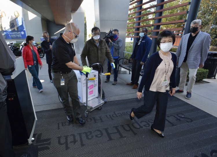 Doses of the Pfizer BioNTech COVID-19 vaccine arrive at Providence St. Joseph Hospital in Orange, Calif. on Wednesday, Dec. 16. 