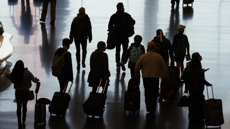 Travelers make their way through Salt Lake City International Airport a day before Thanksgiving. More than 1 million people have passed through U.S. airport security checkpoints in each of the past two days in a sign that public health pleas to avoid holiday travel are being ignored. 