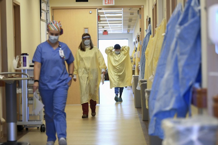 Nurses and medical staff make their way through the seventh floor COVID-19 unit at East Alabama Medical Center Thursday, Dec. 10, in Opelika, Ala. 