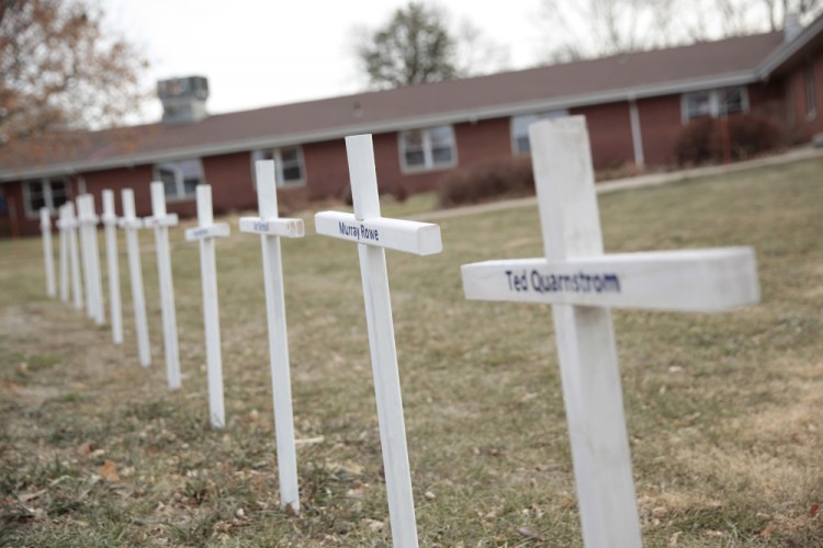 White crosses on the lawn of Good Samaritan Society nursing home in Canton, S.D., commemorate residents who have died in recent weeks of the coronavirus. (AP Photo/Stephen Groves)