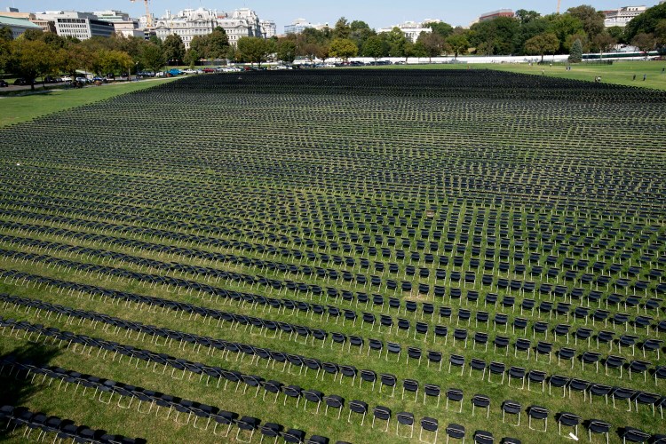 Hundreds of empty chairs, who represent a fraction of the more than 200,000 lives lost due to COVID-19, are displayed during the National COVID-19 Remembrance, at The Ellipse outside the South side of the White House, Sunday, Oct. 4, 2020, in Washington. (AP Photo/Jose Luis Magana)