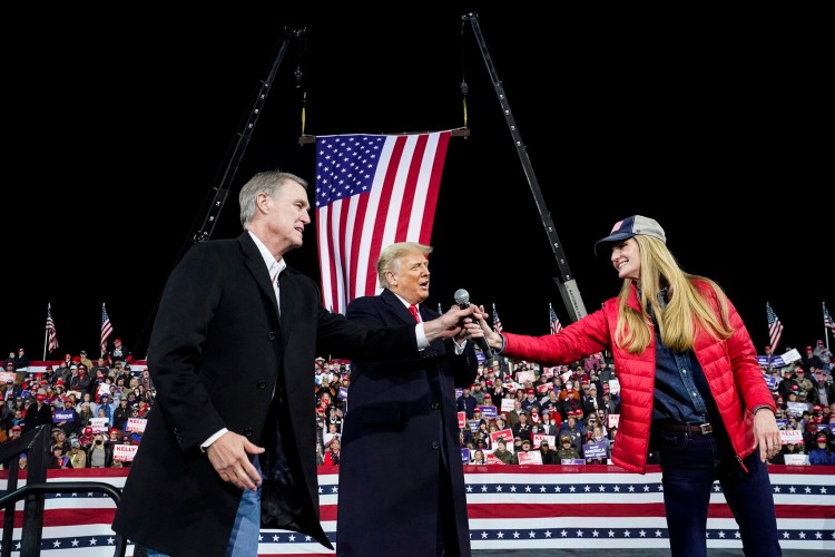 Georgia Sens. David Perdue, left, and Kelly Loeffler share the stage with President Trump during a rally Saturday night in Valdosta, Ga. 
