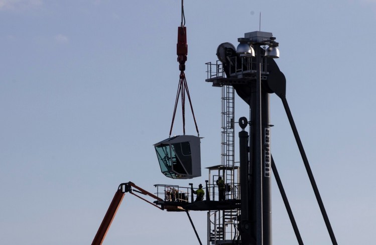 The cab of the new Liebherr mobile harbor crane is lifted into place by the International Marine Terminal's other crane at on Tuesday in Portland. The additional crane is the final step in a multimillion-dollar improvement project.