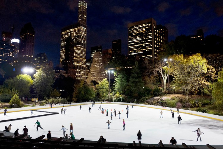 In this Thursday, Nov. 3 photo, skaters take to the ice at Wollman Rink in New York's Central Park. Skaters may notice something missing from the park's two ice rinks this winter — President Donald Trump's name, a spokeswoman for the city Parks Department, said in a statement Wednesday, Oct. 23, 2019. The Trump Organization still operates the rinks but has removed the Trump name from the outer boards, the skate rental counters and elsewhere. (AP Photo/Mark Lennihan)