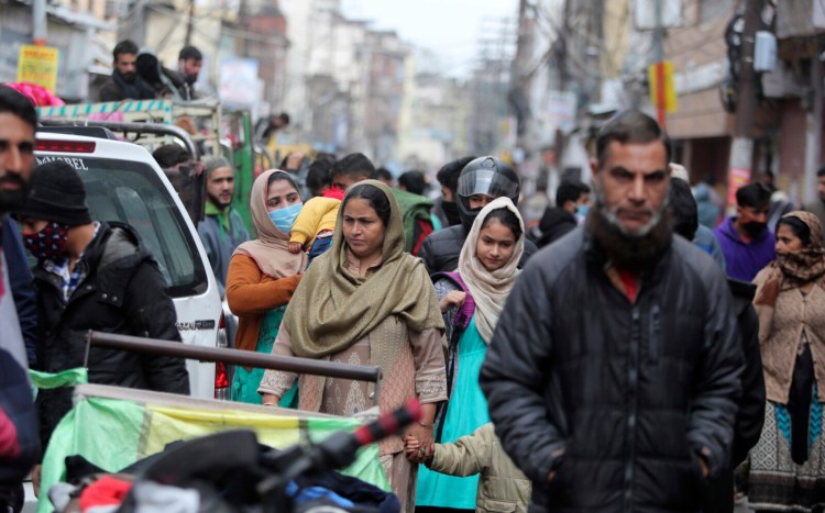Indians, some of them, wearing face masks as a precautionary measure against the coronavirus crowd a Sunday market in Jammu, India, Sunday, Jan.3, 2021. India authorized two COVID-19 vaccines on Sunday, paving the way for a huge inoculation program to stem the coronavirus pandemic in the world’s second most populous country. (AP Photo/Channi Anand)