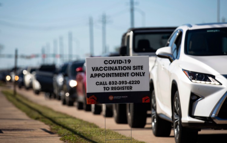 People who qualify under Phase 1A or Phase 1B of Texas'  guidelines wait for their turn to receive the COVID-19 vaccine on Sunday at a Houston Health Department's COVID-19 clinic. 