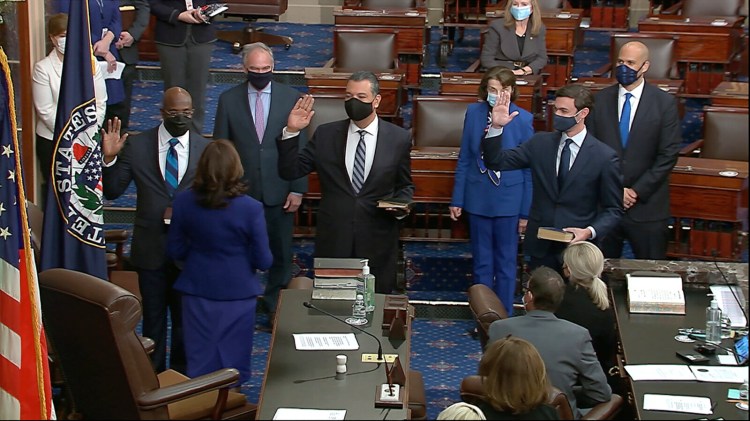 In this image from video, Vice President Kamala Harris swears in Sen. Raphael Warnock, D-Ga., Sen. Alex Padilla, D-Calif., and Sen. Jon Ossoff, D-Ga., on the floor of the Senate on Wednesday on Capitol Hill in Washington. 