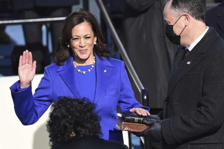 Kamala Harris is sworn in as vice president by Supreme Court Justice Sonia Sotomayor as Harris' husband, Doug Emhoff, holds the Bible during the 59th Presidential Inauguration on Wednesday. 
