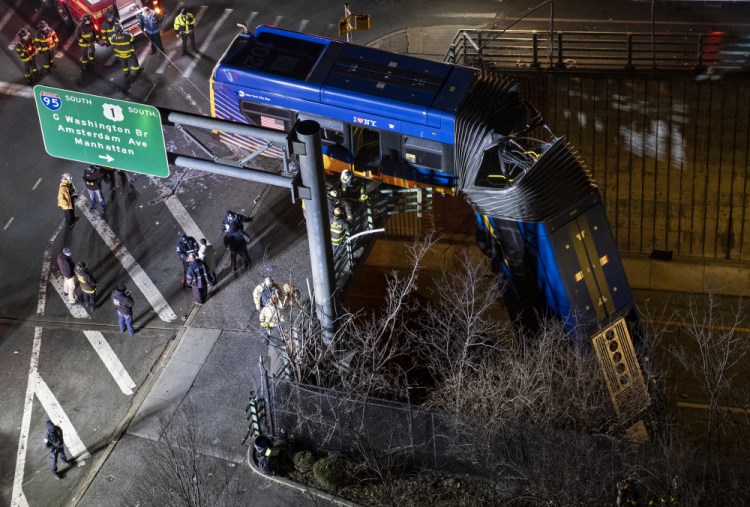 A bus in New York City that careened off a road in the Bronx neighborhood of New York is left dangling from an overpass Friday. 

