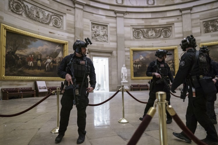 Members of the U.S. Secret Service Counter Assault Team walk through the Rotunda as they and other federal police forces responded as violent protesters loyal to President Donald Trump stormed the U.S. Capitol Wednesday.