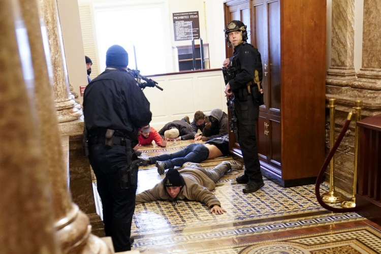 U.S. Capitol Police hold protesters at gun-point near the House Chamber on Wednesday inside the U.S. Capitol in Washington.