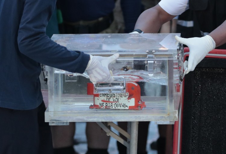 Members of the National Transportation Safety Committee carry a box containing the flight data recorder from the Sriwijaya Air flight SJ-182 retrieved from the Java Sea on Tuesday. Officials hope it'll reveal why the jet crashed shortly after take off on Saturday.