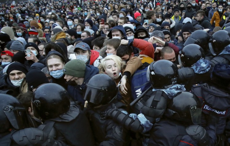 People clash with police during a protest against the jailing of opposition leader Alexei Navalny in St.Petersburg, Russia, Saturday, Jan. 23. Russian police on Saturday arrested hundreds of protesters who took to the streets in temperatures as low as minus-58 F to demand the release of Alexei Navalny, the country's top opposition figure. 