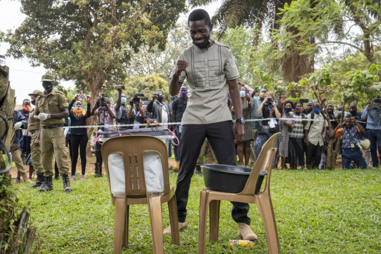 Uganda's leading opposition challenger Bobi Wine reacts after voting in Kampala, Uganda, Thursday.