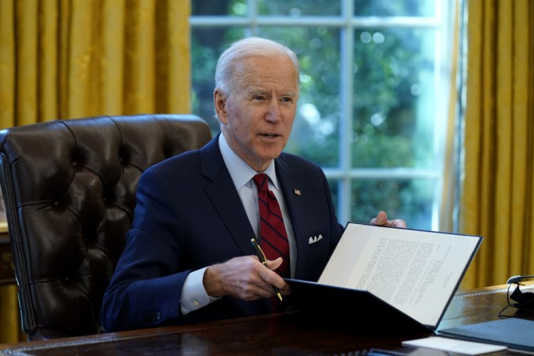 President Biden signs a series of executive orders on health care, in the Oval Office of the White House on Thursday in Washington. 