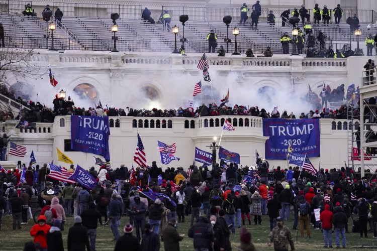 A violent mob, loyal to President Trump, storms the Capitol in Washington on Jan. 6. The FBI says dozens of people on a terror watch list were in D.C. that day. 