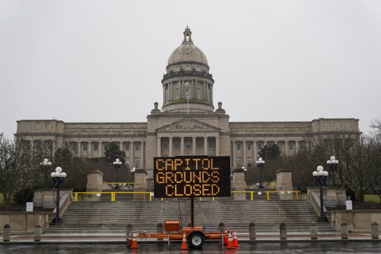 A sign displayed outside the Capitol building in Frankfort, Ky., advises that the grounds are closed, Sunday. Some state capitols are closed, fences are up and extra police are in place at statehouses across the U.S. as authorities brace for potentially violent demonstrations over the coming days.
