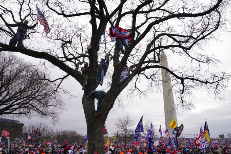 Supporters of President Trump participate in a rally in Washington on Jan. 6. Both within and outside the walls of the Capitol, banners and symbols of white supremacy and anti-government extremism were displayed as an insurrectionist mob swarmed the U.S. Capitol.