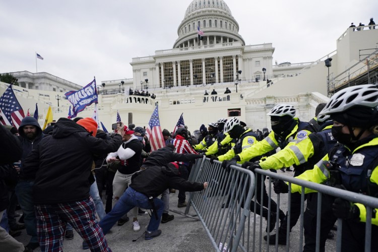 Trump supporters try to break through a police barrier at the Capitol in Washington during the Jan. 6 riot. The acting chief of the Capitol Police said on Thursday that “vast improvements" are needed to protect the Capitol and adjacent office buildings, including permanent fencing.