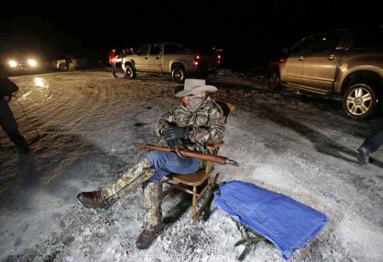 Arizona rancher LaVoy Finicum holds a gun as he guards the Malheur National Wildlife Refuge near Burns, Ore., in 2016. Finicum, one of the leaders of the armed takeover of the refuge, was later shot by state police officers after he fled an attempted police stop. Experts say right-wing extremism like the Malheur takeover had previously mostly played out in isolated pockets or smaller cities in America before the deadly assault by rioters on the U.S. Capitol earlier this month. 

