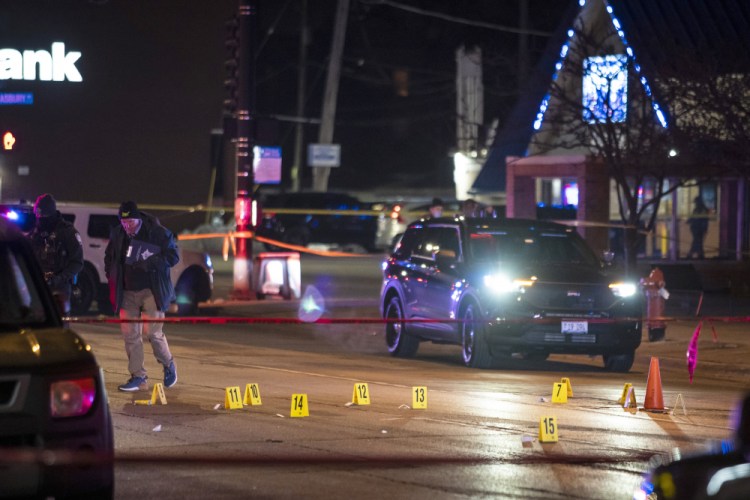 Chicago and Evanston police investigate a crime scene after a gunman went on a shooting spree before being killed by police during a shootout Saturday night in Evanston, Ill.