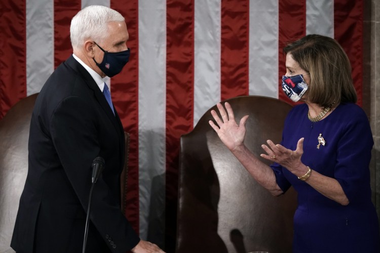 Speaker of the House Nancy Pelosi, D-Calif., and Vice President Mike Pence talk before a joint session of the House and Senate convenes to count the Electoral College votes cast in November's election, at the Capitol in Washington, on Wednesday. 