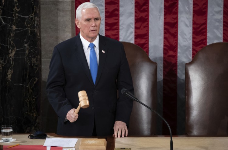 Vice President Mike Pence officiates as a joint session of the House and Senate convenes to confirm the Electoral College votes cast in November's election, at the Capitol in Washington, Wednesday, Jan. 6. 