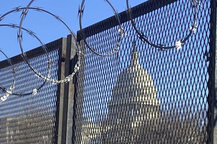 Riot fencing and razor wire reinforce the security zone on Capitol Hill in Washington. 