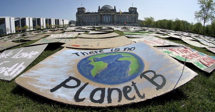 Activists place thousands of protest placards in front of the Reichstag building, home of the german federal parliament, Bundestag, during a protest rally of the 'Fridays for Future' movement in Berlin, Germany in April 2020. 