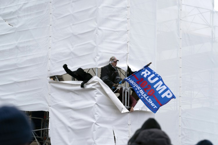 Trump supporters gather outside the Capitol, Wednesday, Jan. 6, 2021, in Washington. As Congress prepares to affirm President-elect Joe Biden's victory, thousands of people have gathered to show their support for President Donald Trump and his claims of election fraud. 