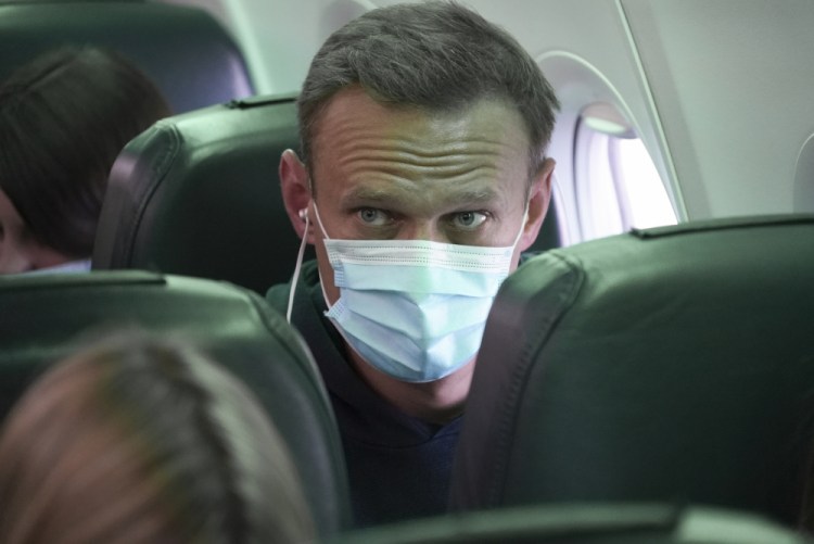 Alexei Navalny sits on the plane prior to a flight to Moscow at the Airport Berlin Brandenburg in Schoenefeld, Germany, on Sunday.

