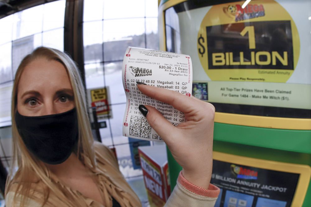 A patron, who did not want to give her name, shows the ticket she had just purchased for the Mega Millions lottery drawing at the vending kiosk in a Smoker Friendly store Friday in Cranberry Township, Pa. 

