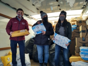 From left, News Center Maine's Mike Slifer, Jen Simpson and Molly Roberts pack a truck with purchases made from Coats and Toys for Kids Wish List.jpg