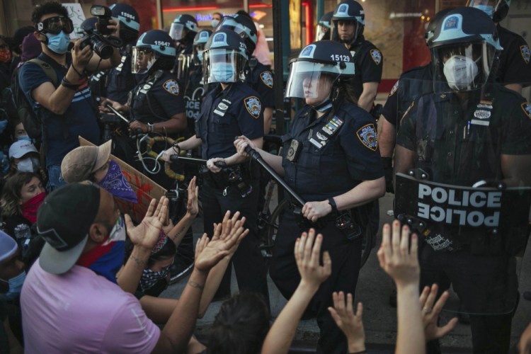 New York City Police face off with activists during a protest march May 31 in the Bedford-Stuyvesant section of the Brooklyn borough of New York.
