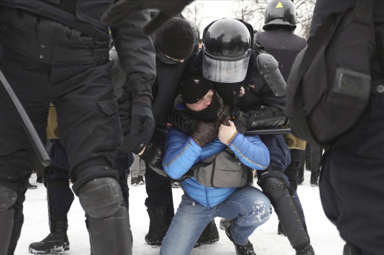 Police detain protesters during a demonstration against the jailing of opposition leader Alexei Navalny in St. Petersburg, Russia, on Sunday. (AP Photo/Valentin Egorshin)