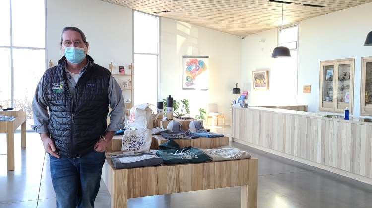Scott Howard, owner of SeaWeed Co., one of the state's first adult-use marijuana stores, stands in his South Portland shop earlier this month. Howard has been cited by the state for using a prohibited product logo, among other issues.