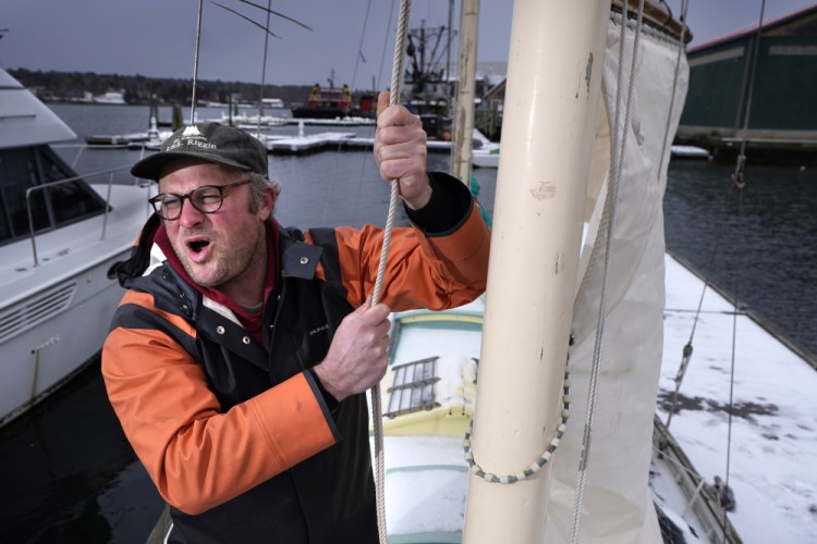 Bennett Konesni sings a sea shanty while raising a sail on his ketch on Thursday in Belfast, Maine. Konesni started singing sea shanties aboard a schooner in Penobscot Bay and has since traveled the world studying work songs. The app TikTok helped sea shanties surge into the mainstream.
